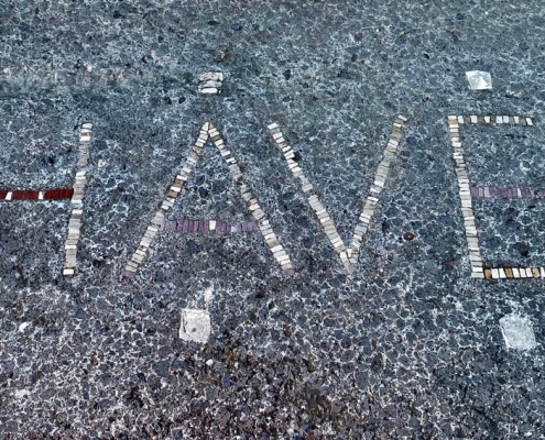 The detail of the inscription "have", (welcome), by the entrance to the House of the Faun in Pompeii.